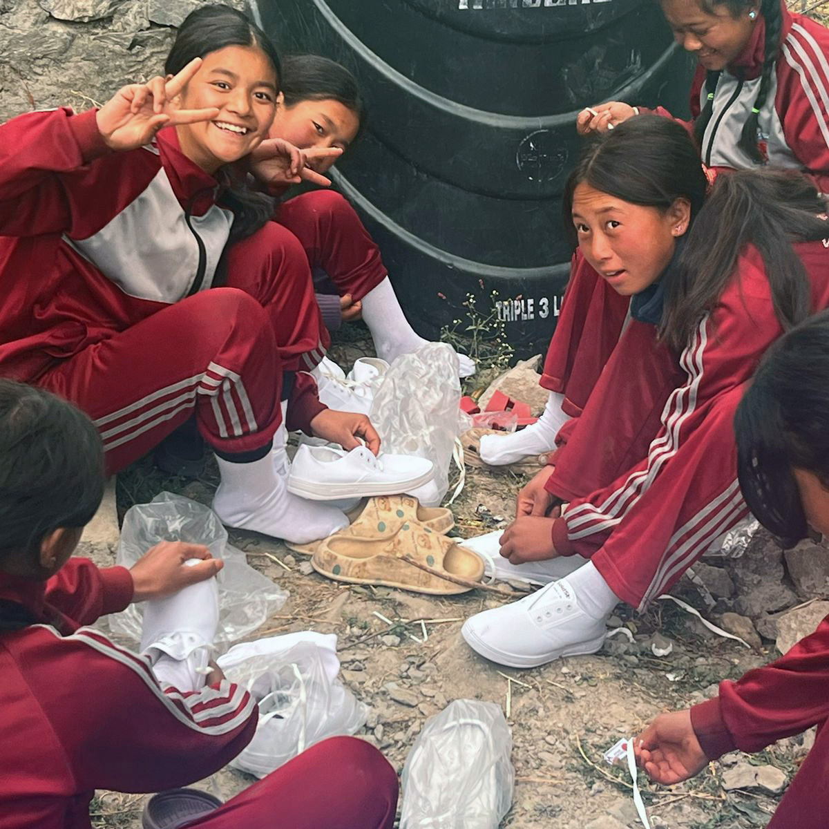 Students receiving shoes through Trek Trainers philanthropic support in Nepal